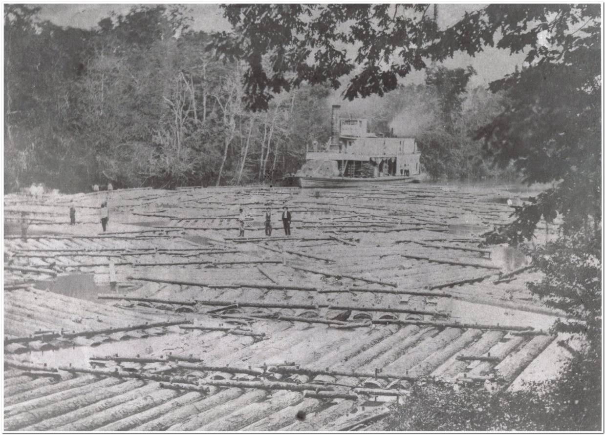 Photo of Steamboat Laura trapped at the junction of the Angelina and Neches Rivers, waiting for higher water amid log rafts.